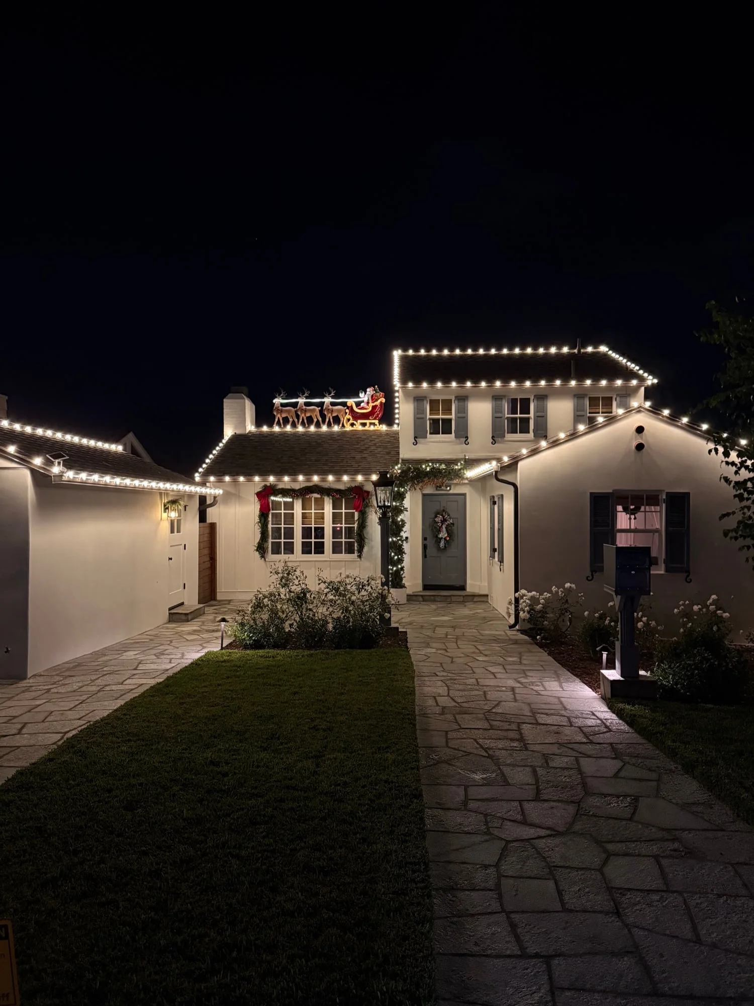 Christmas light installation in La Jolla with Santa sleigh rooftop display