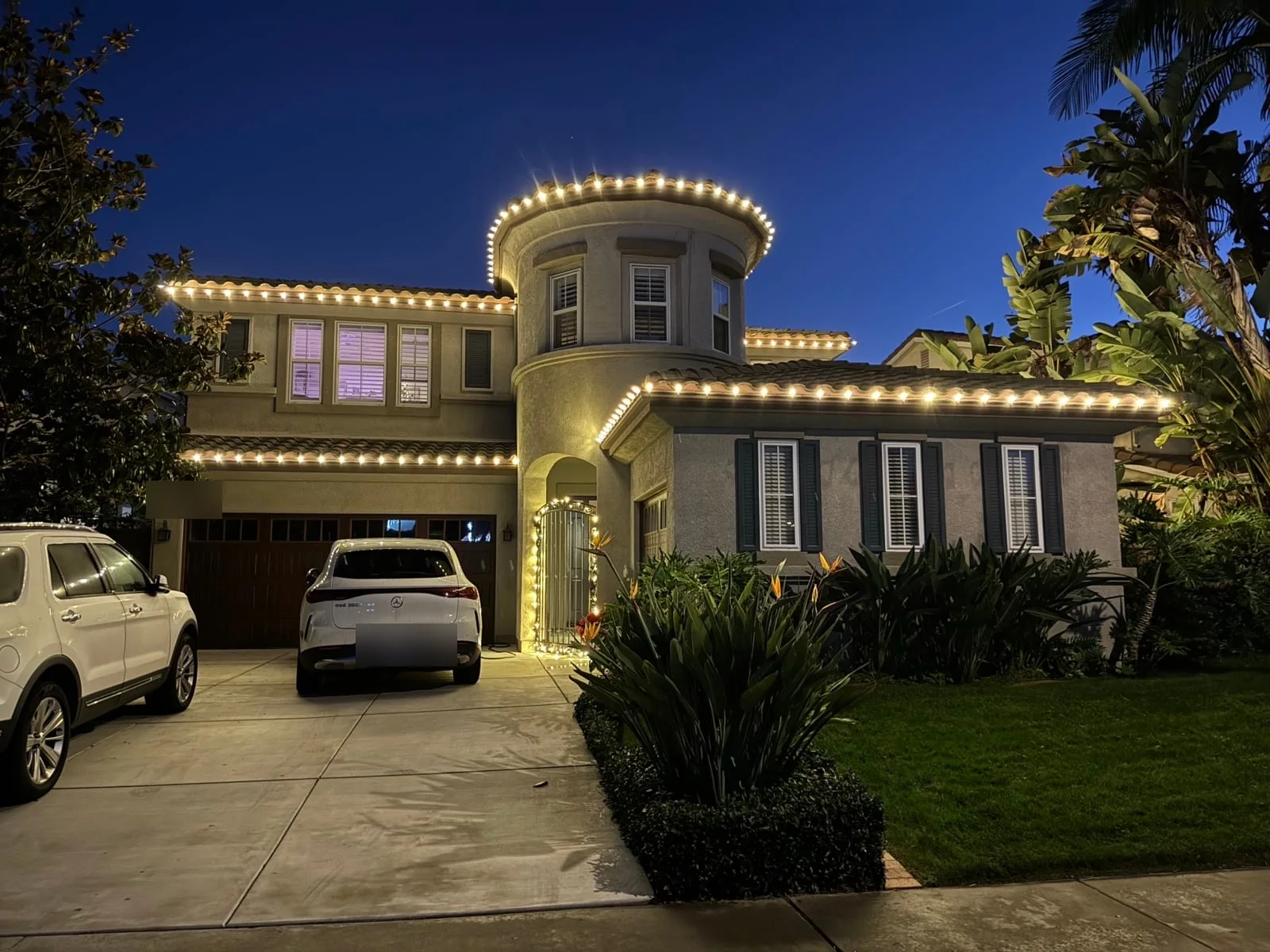 Permanent holiday lighting on a San Diego home at dusk